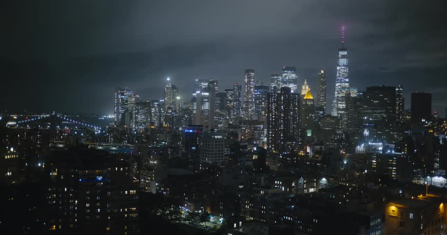 Aerial view of the tall skyscrapers in the skyline of new york city lights at night