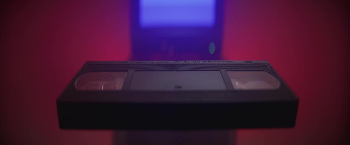 A video cassette is near the television