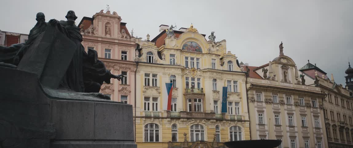 Partial view of the Jan Hus monument with stately homes behind in Old Town Square, Prague, Czech Republic