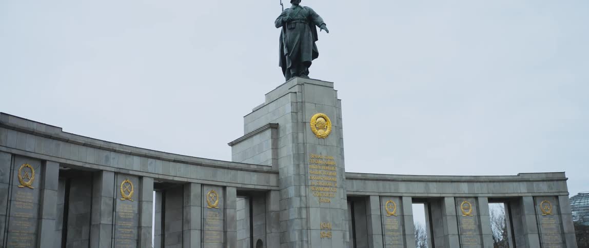A statue of a Soviet soldier stands atop the Soviet War Memorial Tiergarten in Berlin, Germany