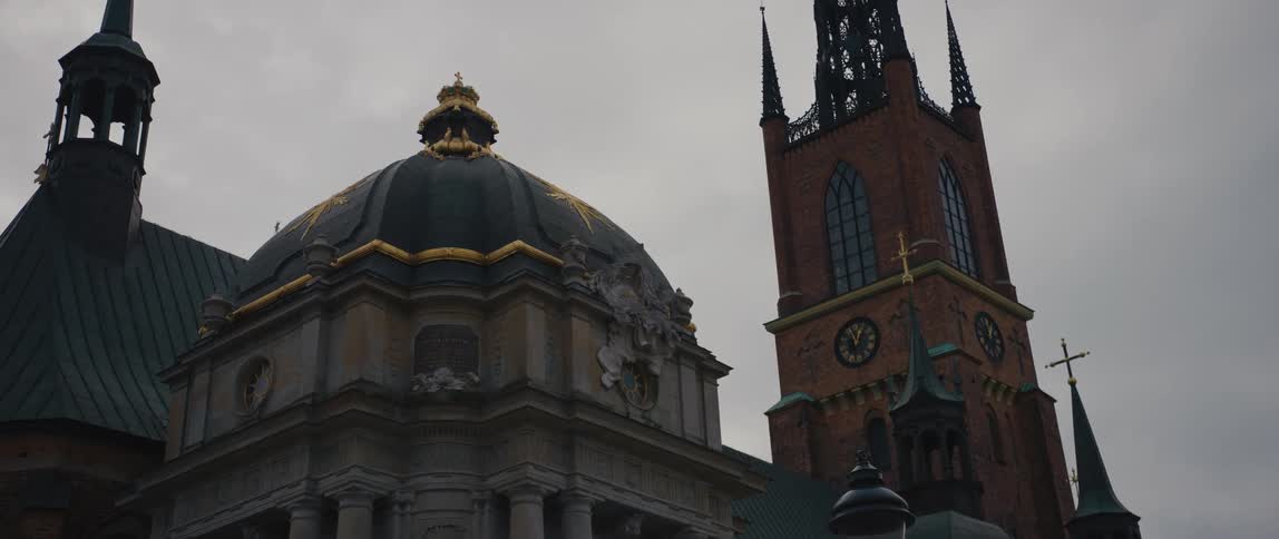 City church with tower and dome against the cloudy sky