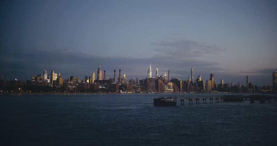 An ocean off the coast of a metropolis during the day
