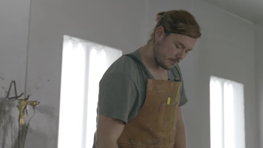 A man is moving jars in front of him
