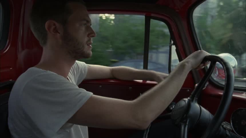 Man driving a pickup truck as seen from the passenger seat