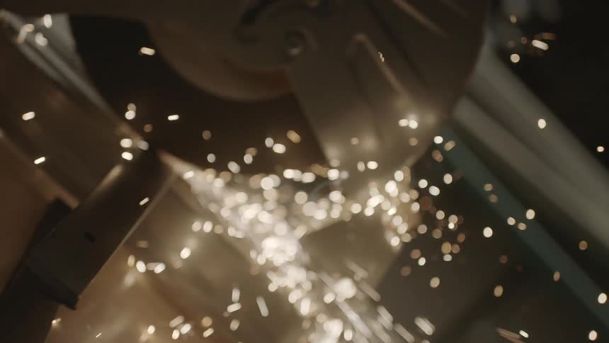 Sparks are flying from a saw cutting metal