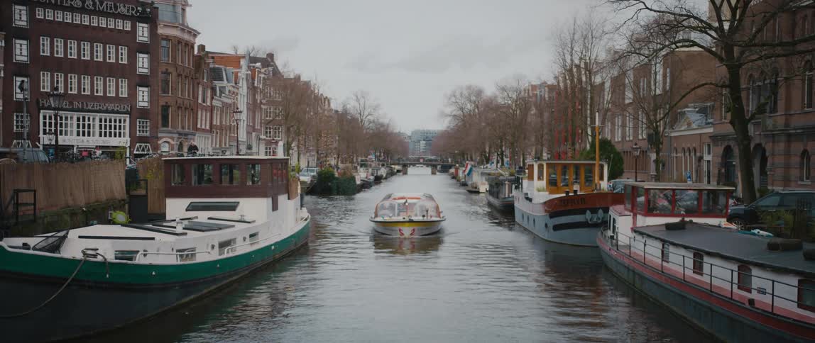 Boats line a canal in Amsterdam