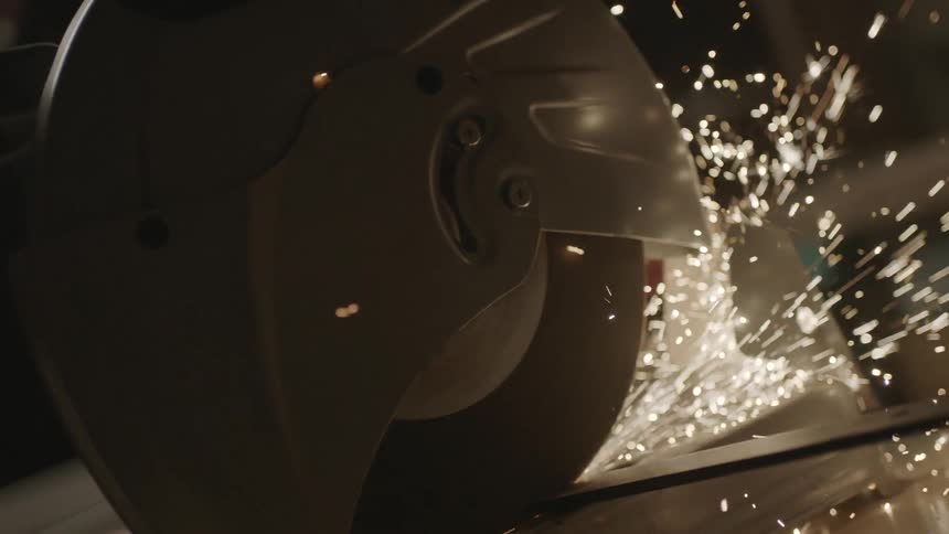 A person saws a strip of metal