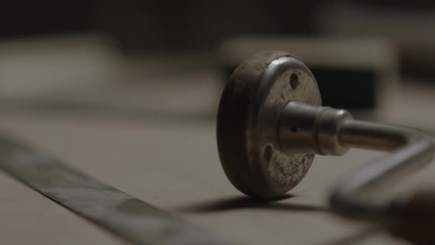 A metal tool sitting on a desk