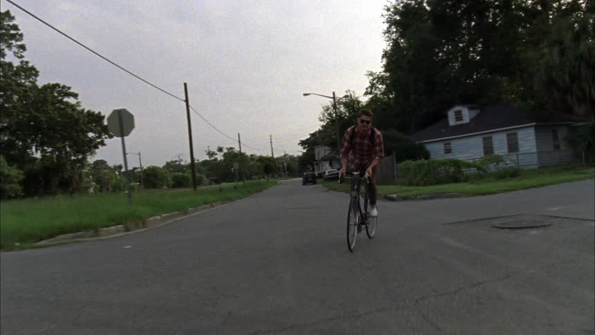 A man riding a bike turns onto a road