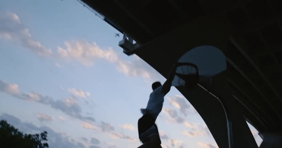 A man runs and dunks the basketball