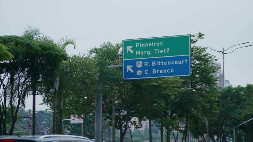 Vehicles drive down a highway headed toward downtown