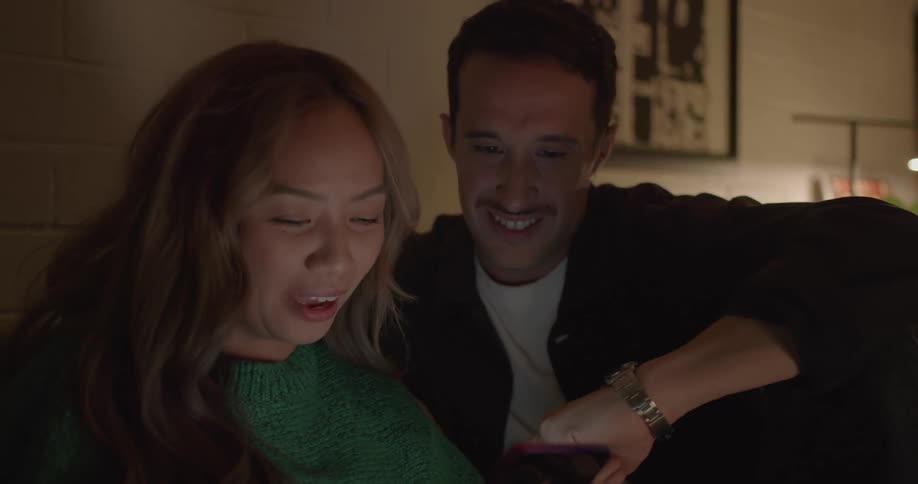 A couple look at their phone together