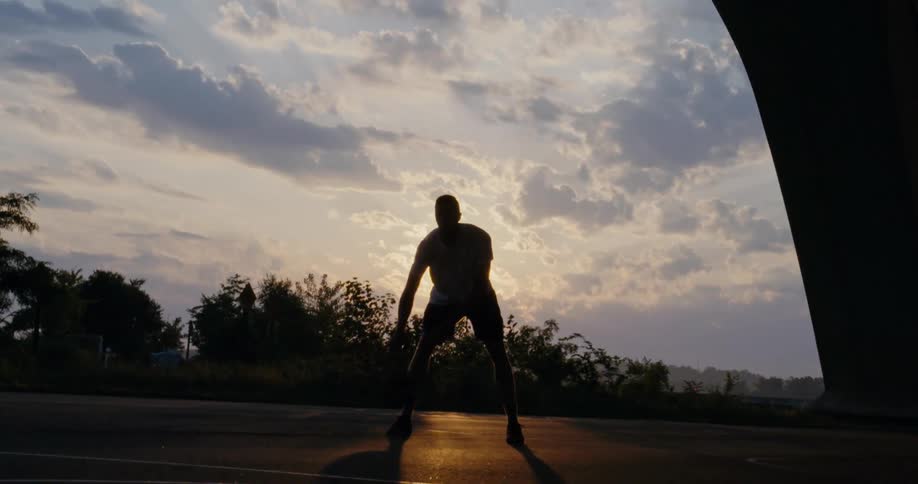 A man dribbles a basketball
