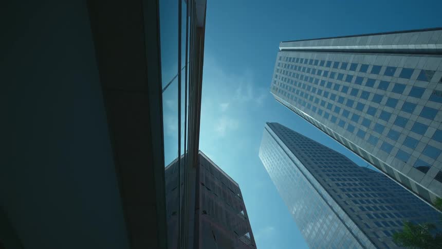Several skyscrapers stand tall underneath a brilliantly blue sky
