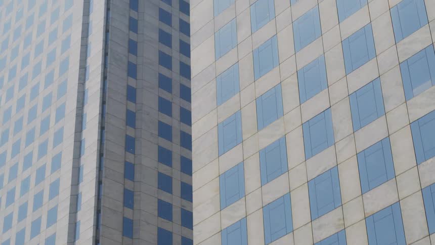 Similar looking skyscrapers stand close together