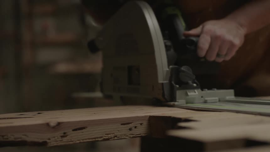 Person using a power saw in a workshop