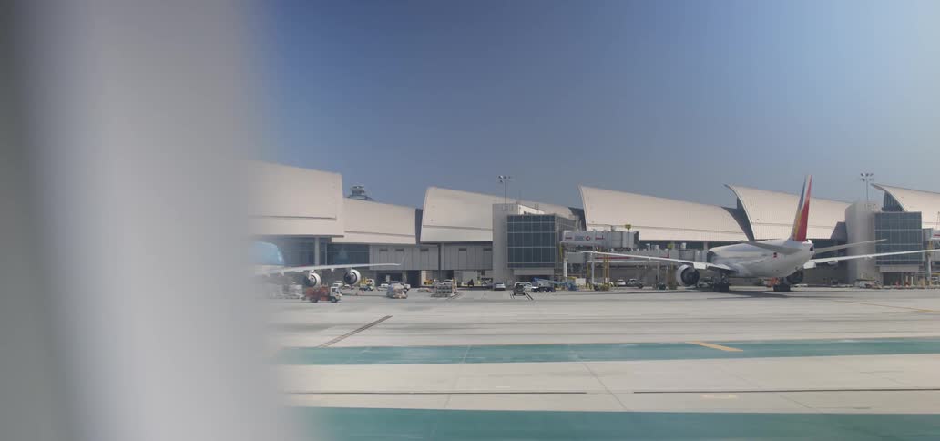 An airplane traveling down a runway in the daytime