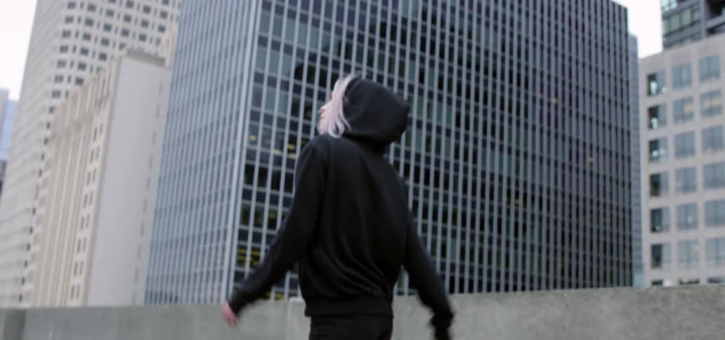 A woman walking outdoors in a city