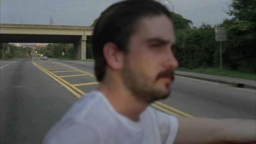 Man riding in the back of a red pickup