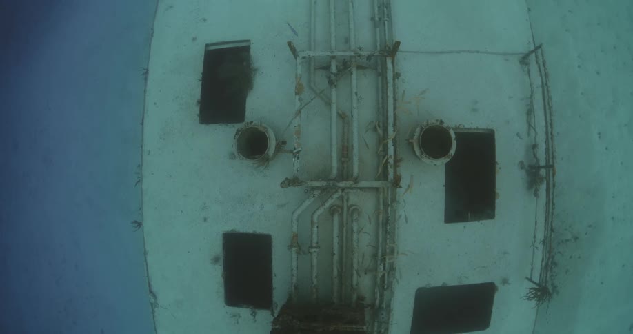 Underwater overhead view of a sunken ship at the bottom of the ocean