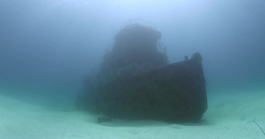 Abandoned shipwreck at the bottom of the ocean floor