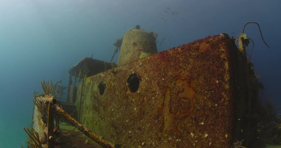 The wreckage of a sea vessel on the sea floor during the day