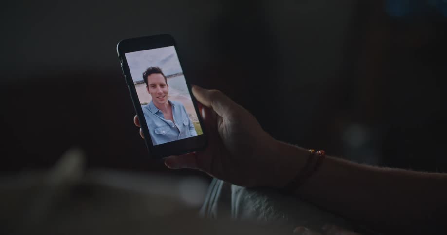 Someone is holding their phone and having a video conference