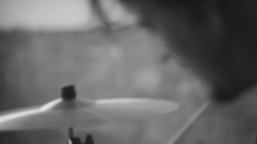 Man plays drums in meadow