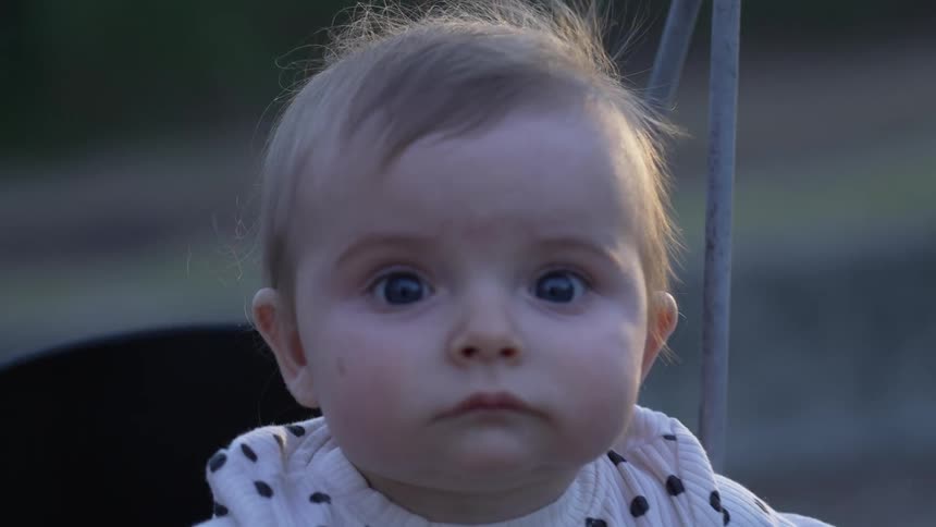 A baby swinging in a swing