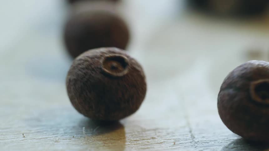 Allspice Pimento rolls on a wooden counter top
