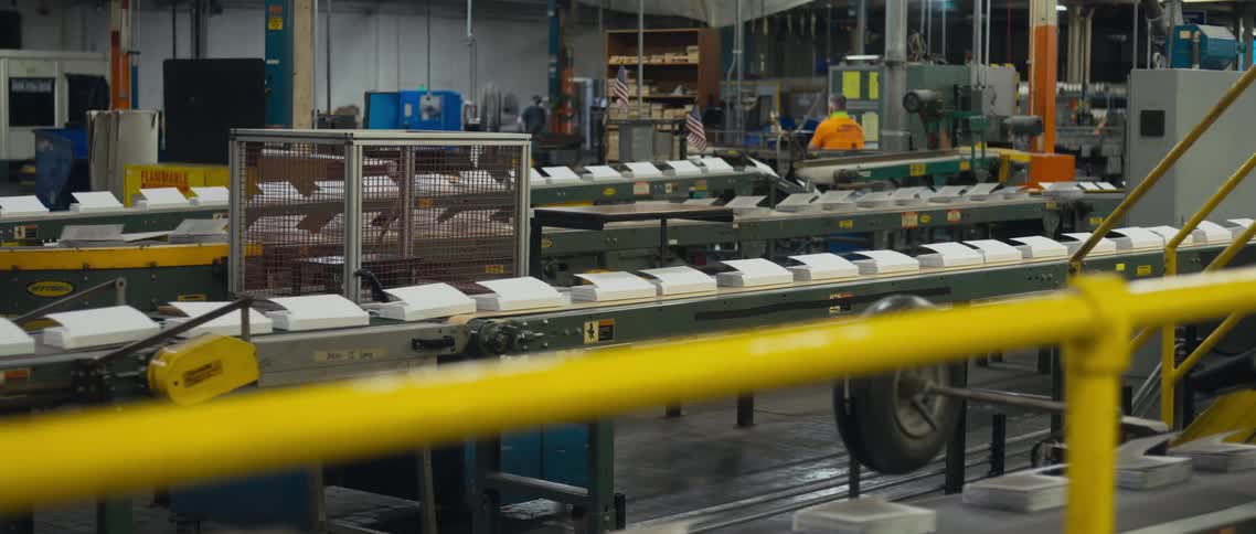 Books moving along a conveyor belt in a manufacturing facility