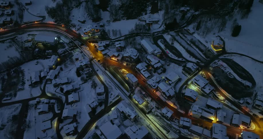 A road through a small town covered in snow