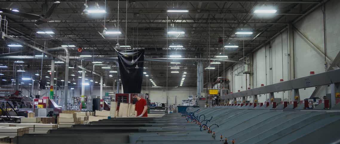 Employees work in boxing area of factory