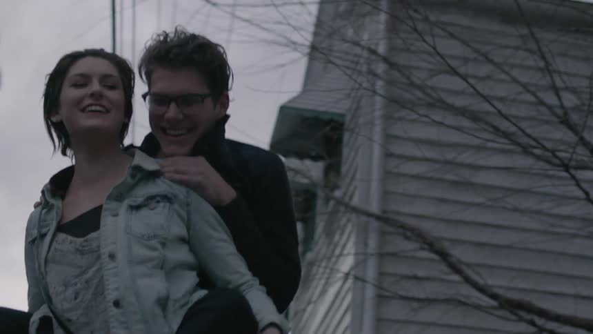 A woman is giving a man a piggyback ride