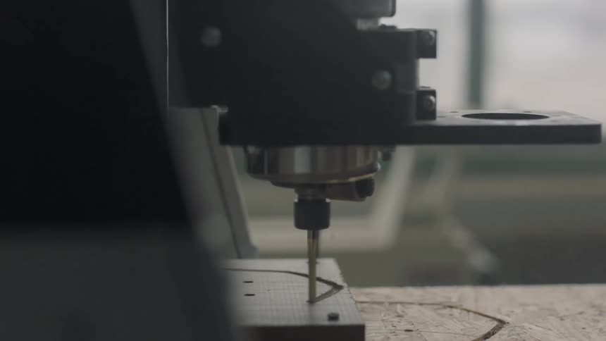 A machine cuts a piece of wood