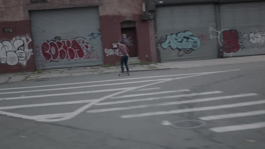 Person riding a skateboard on a city street
