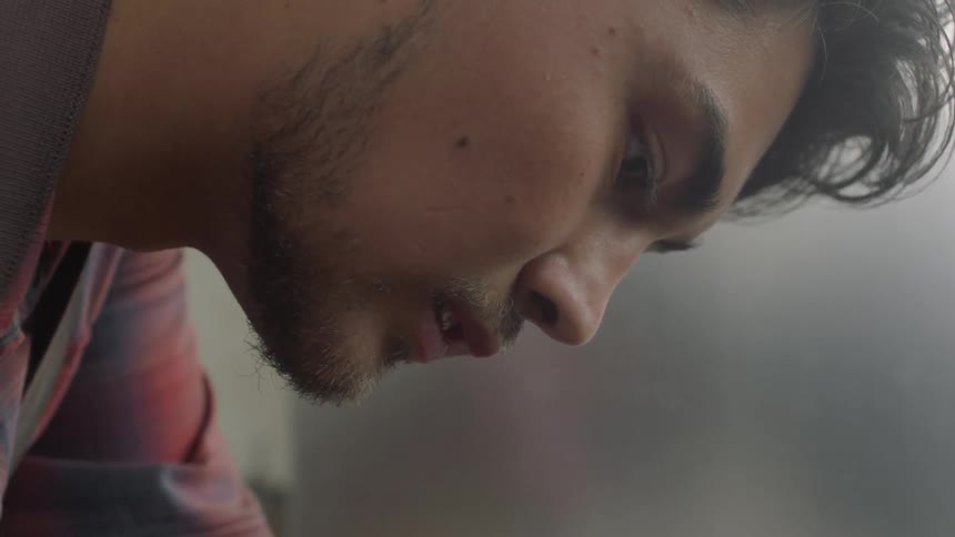 Close up of a man's face while he works