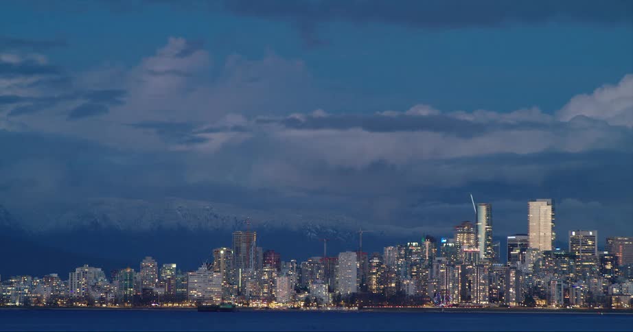 City skyline with distant skyscrapers and office buildings on the horizon at dusk