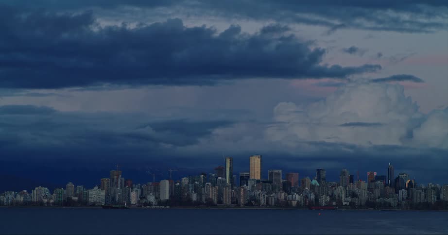 City skyline with distant skyscrapers and office buildings on the horizon at dusk