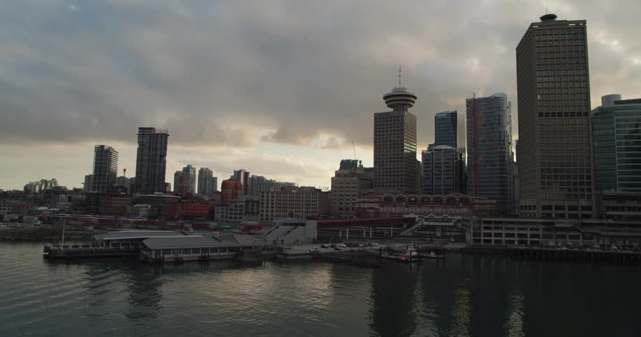 Waterfront city skyline shown at sunset
