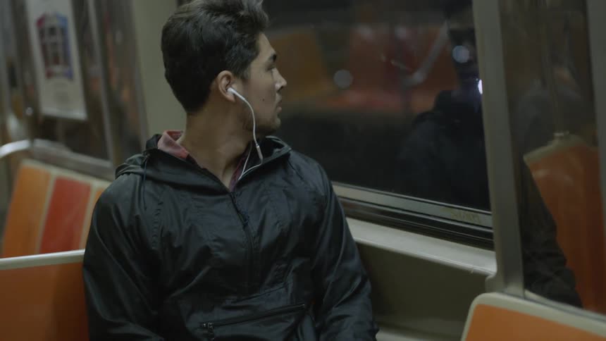 Man sitting in a subway car