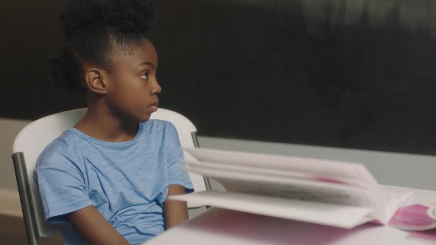 A child is sitting in class