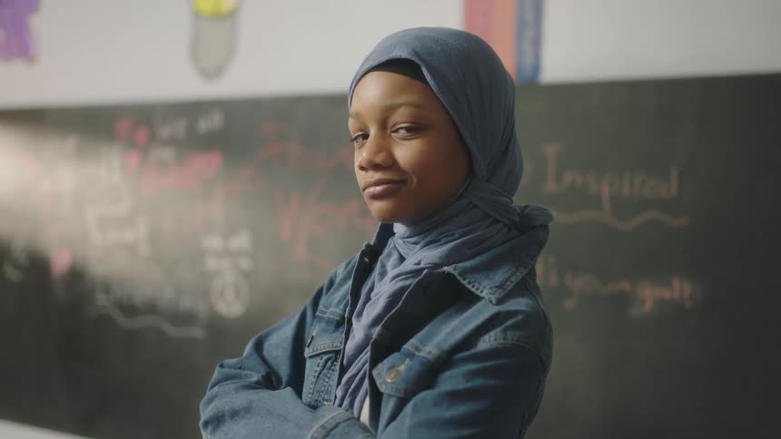 A student poses in the classroom