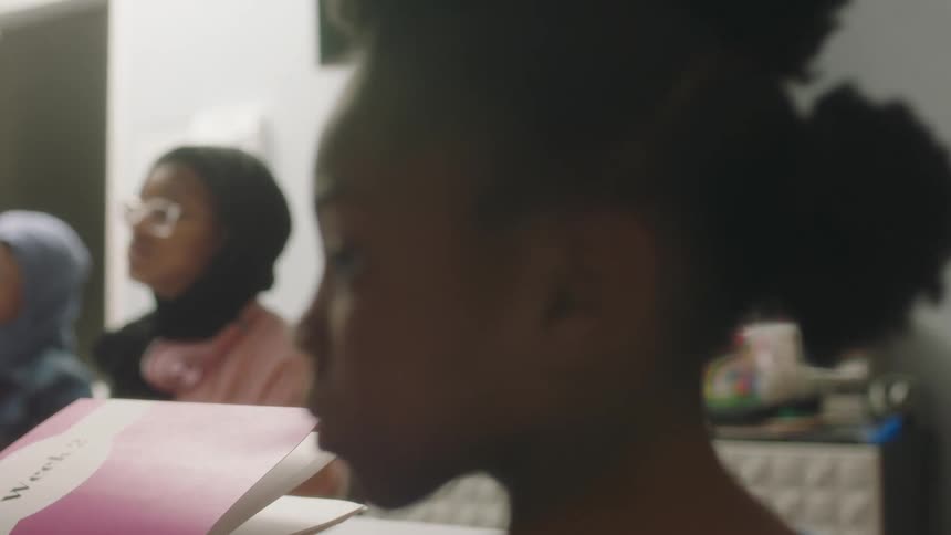 Students sit in class listening