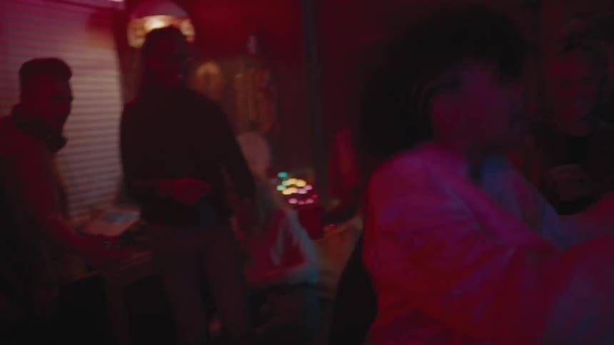 People cheer as a young girl sings and dances during a party