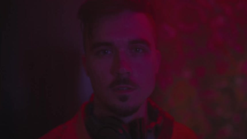 A man is standing in a dark room