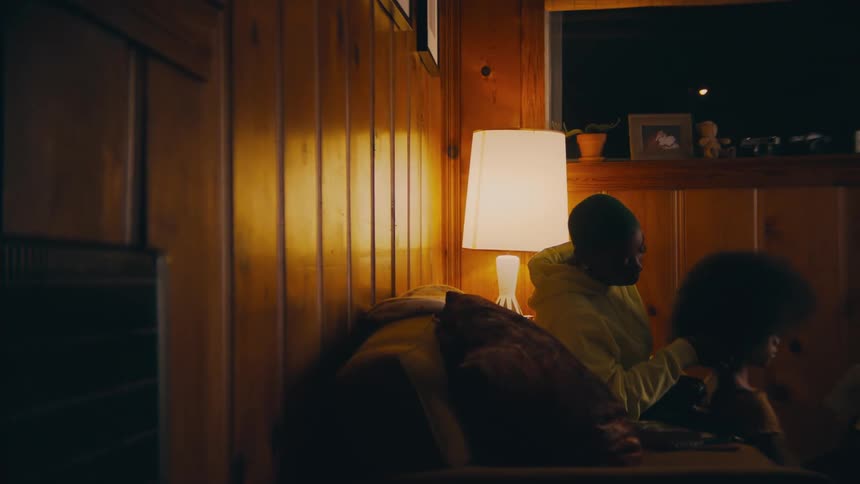 A man and woman sit on the couch together