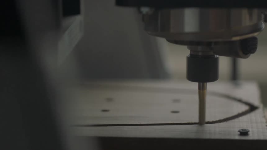 A drill press or router is used to carve a piece of wood