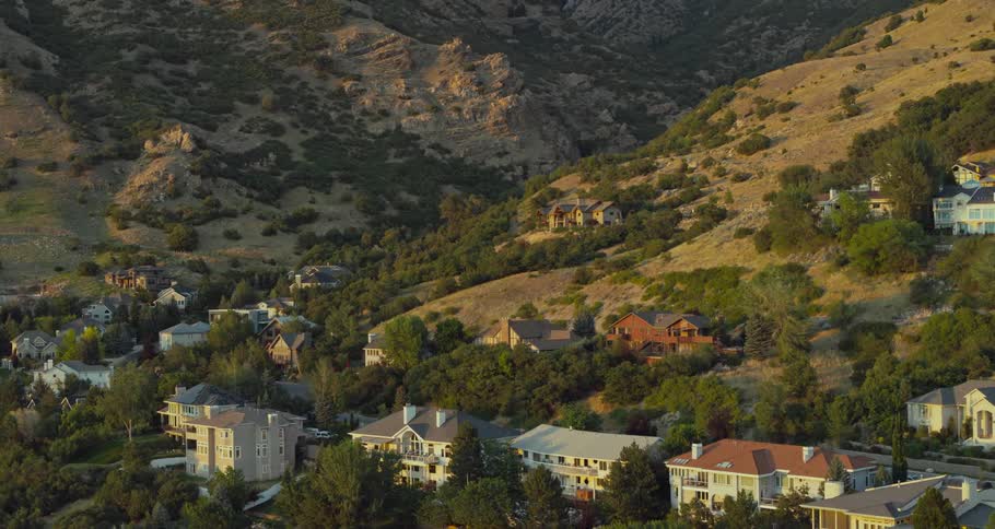 Mansions occupy mountain slope in valley nestled among trees
