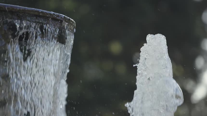 Water rushes out of a fountain in a park